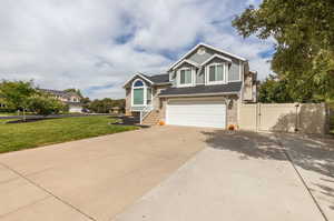 View of front of home featuring a garage and a front lawn