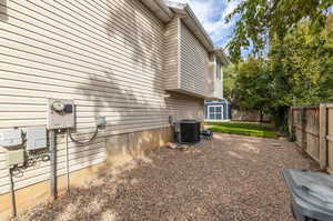 View of side of property featuring a storage unit and central AC