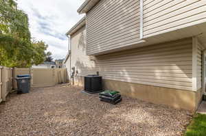 View of side of home featuring central AC unit