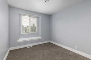 Spare room with dark carpet