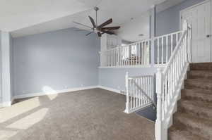 Stairway featuring lofted ceiling and carpet floors