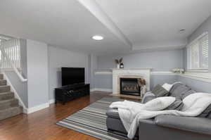 Living room featuring a textured ceiling and dark wood-type flooring