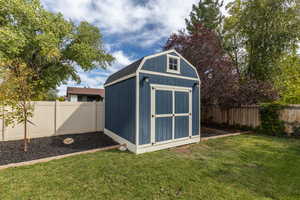 View of outdoor structure featuring a yard