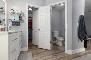 Bathroom with vanity, toilet, and hardwood / wood-style flooring