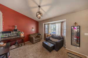 Carpeted living room with vaulted ceiling