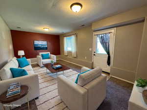 Carpeted family room with large window to back yard.  Door to back yard.