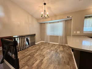 Open space for dining.  Window at dining area.  Chandelier.  Laminate flooring.  Open flow.