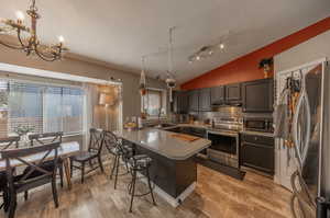 Stainless steel appliances.  Newer stove/oven.  Fridge stays.  Dining area.  Laminate flooring.