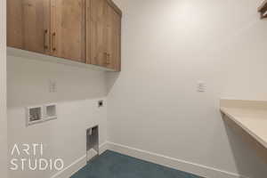 Laundry room with cabinets, hookup for a washing machine, dark tile patterned flooring, and electric dryer hookup