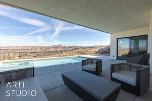 View of patio / terrace featuring a fenced in pool and a mountain view