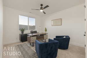 Carpeted home office featuring ceiling fan