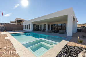 View of swimming pool with an in ground hot tub and a patio area