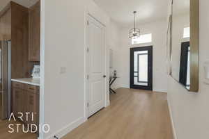 Entryway with a chandelier and light hardwood / wood-style flooring