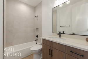 Full bathroom featuring toilet, vanity, and tiled shower / bath combo