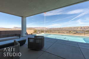 View of swimming pool with a mountain view and outdoor lounge area