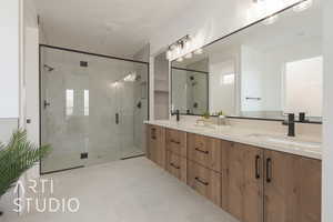 Bathroom featuring tile patterned flooring, a shower with shower door, and vanity