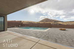 View of pool featuring a patio and a mountain view