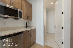 Kitchen with dishwashing machine and sink