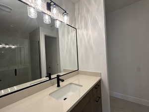 Bathroom with walk in shower and vanity