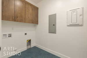 Laundry area featuring cabinets, hookup for a gas dryer, washer hookup, electric panel, and hookup for an electric dryer