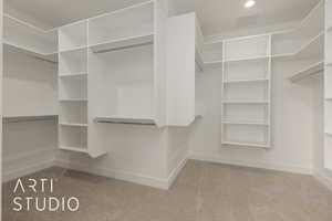 Spacious closet with light carpet