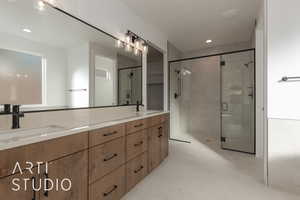 Bathroom featuring tile patterned floors, vanity, and a shower with door