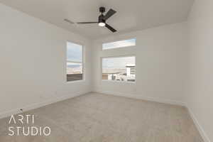 Carpeted spare room with ceiling fan