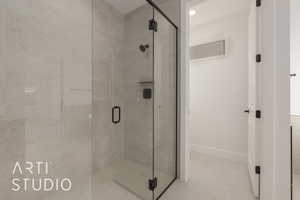 Bathroom featuring a shower with door