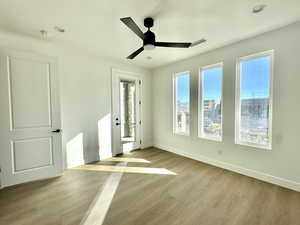 Empty room featuring ceiling fan and light wood-type flooring