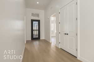 Entrance foyer featuring light hardwood / wood-style flooring