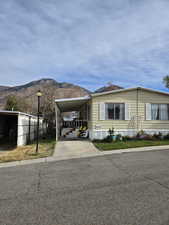 View of front of house featuring a mountain view and a carport