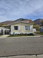 Manufactured / mobile home featuring a mountain view and a carport