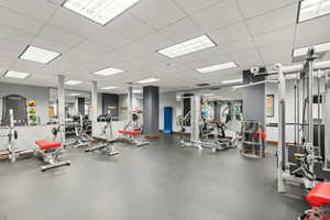 Exercise room featuring a drop ceiling