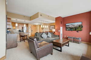 Carpeted living room featuring sink