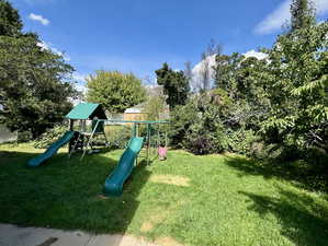 View of play area with a yard