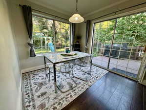 Dining area featuring crown molding, dark hardwood / wood-style flooring, and plenty of natural light