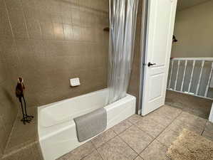 Bathroom featuring tile patterned flooring and shower / bath combo