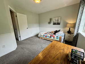 Carpeted bedroom with a textured ceiling