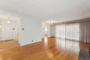 Large living room with beautiful hardwood flooring and sliding doors to the back patio.