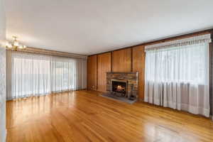 Beautiful hardwood flooring, fireplace, and sliding doors to the back patio.