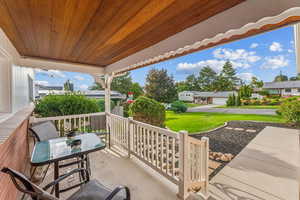 Spacious and covered front patio with redwood overhang.