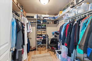 Spacious closet with light hardwood / wood-style floors