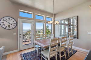 Dining room featuring a notable chandelier and light wood-type flooring