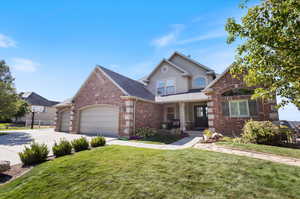 View of front property featuring a front yard and a garage