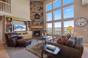 Living room with a high ceiling and a fireplace