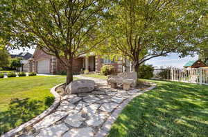 View of front facade featuring a front yard and a garage