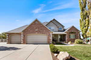 Front facade featuring a front yard and a garage