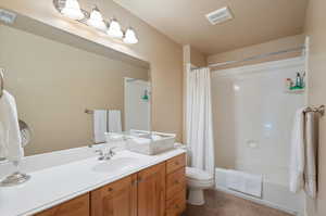 Full bathroom featuring vanity, tile patterned floors, toilet, and shower / bath combo