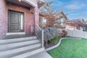 Doorway to property featuring a yard