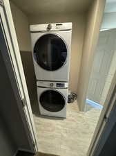 Laundry room featuring stacked washing maching and dryer